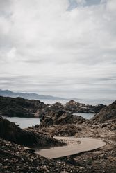 Narrow road near rough boulders beach