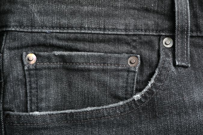 Closeup view of jeans pocket as background, space for text