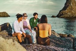 Sunset Gathering of Friends on Rocky Beach