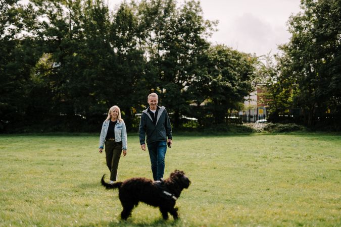 Man and woman walking with dog