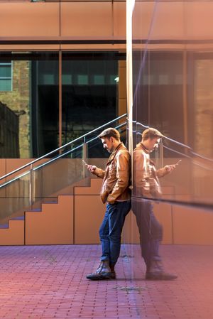 Man using mobile phone in modern building