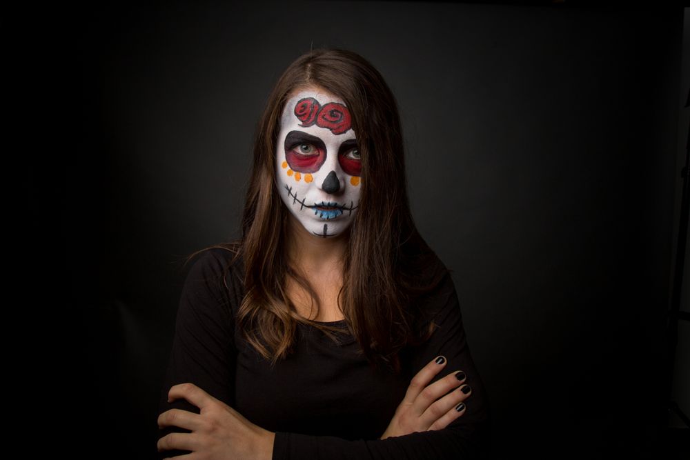 Young woman with creepy face paint