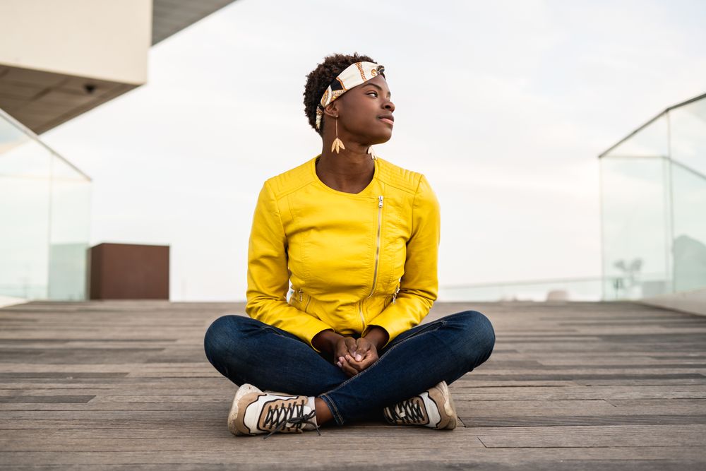 Smart woman sitting on wooden footpath