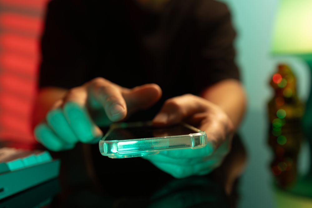 Man Using Smartphone in Red Green Light