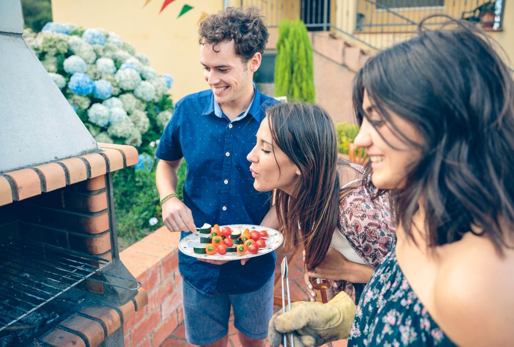 Group of friends cooking in a summer barbecue