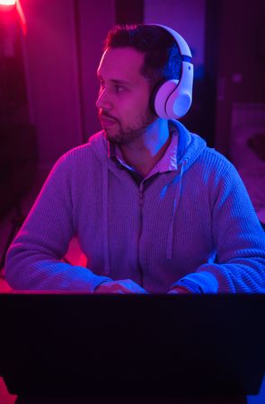 Man listening cheerfully to music with headphones.