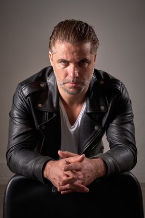 Confident man looking at camera in barbershop