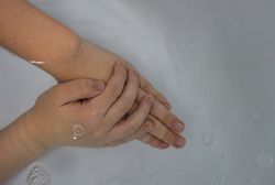 Hands soaking in water