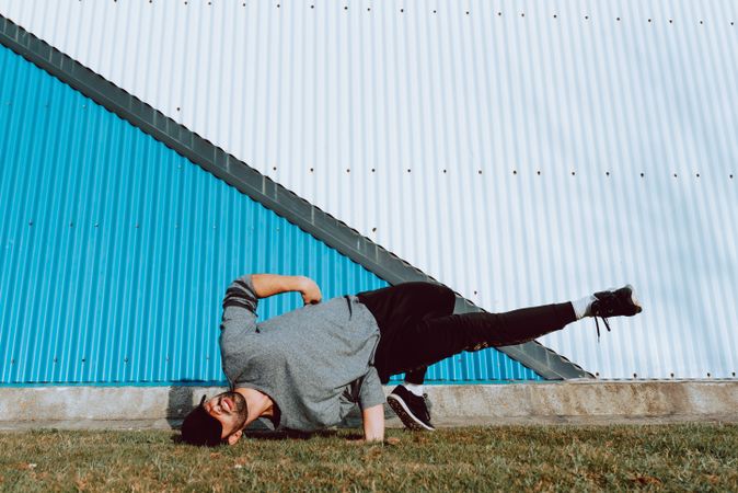 Man performing handstand near wall