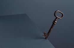 Vintage Key in balance at the edge of the table with dark background