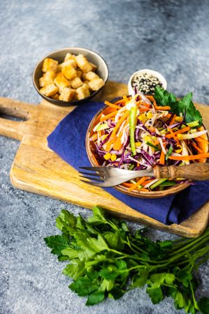 Fresh salad with vegetables in bowl on stone background with copy space