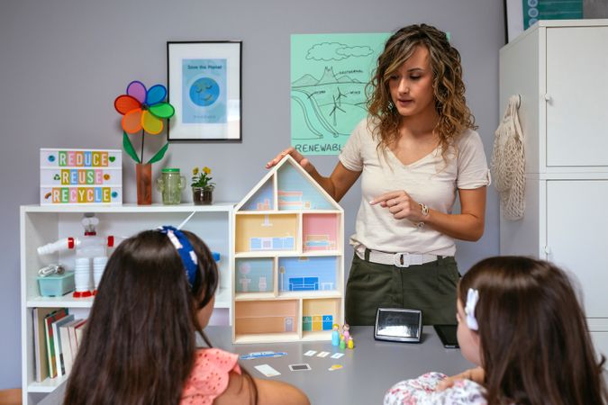 Teacher explaining to her students the parts of a sustainable house