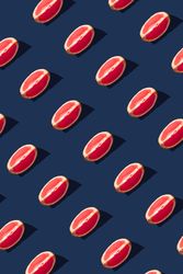 Pattern of grapefruit slices on navy  background