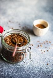 Jar of whole flax seeds on kitchen counter