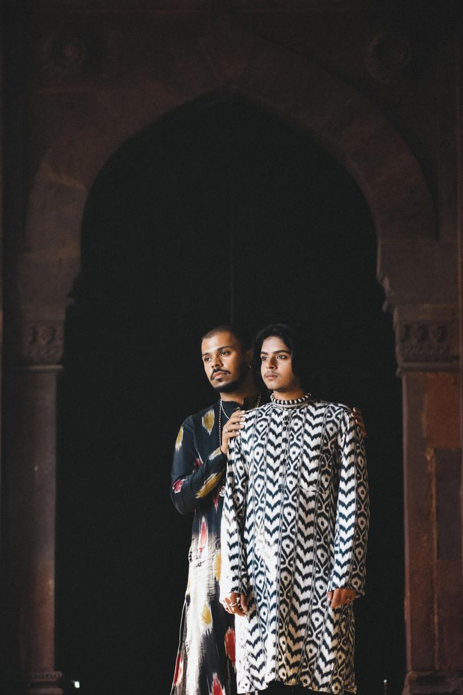 Two men standing beside each other