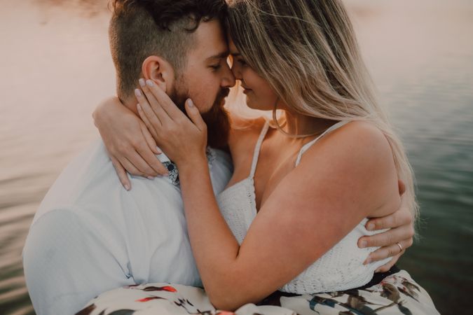 Loving couple standing ankle deep in water on beach