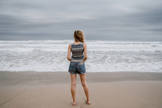 Anonymous young woman relaxing on beach
