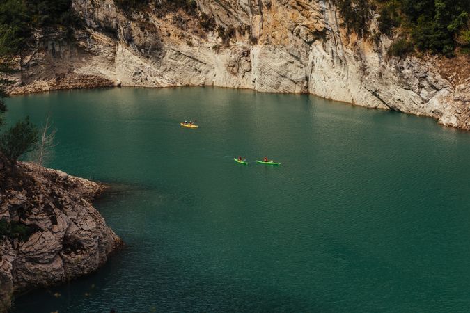 People crossing a river by kayak