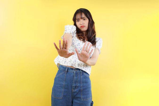 Asian Woman with a Hand Raised in No Gesture