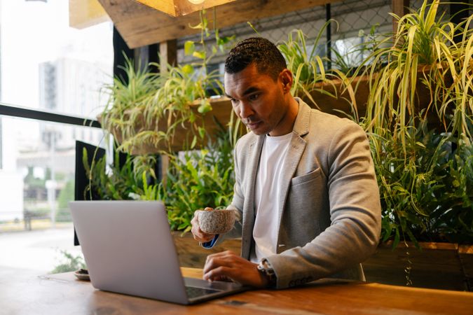 Man working on laptop at cafeteria