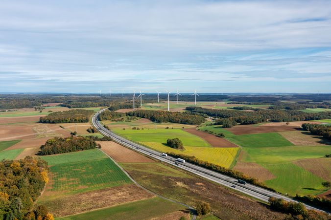 Aerial image with german highway and wind turbines in autumn scenery