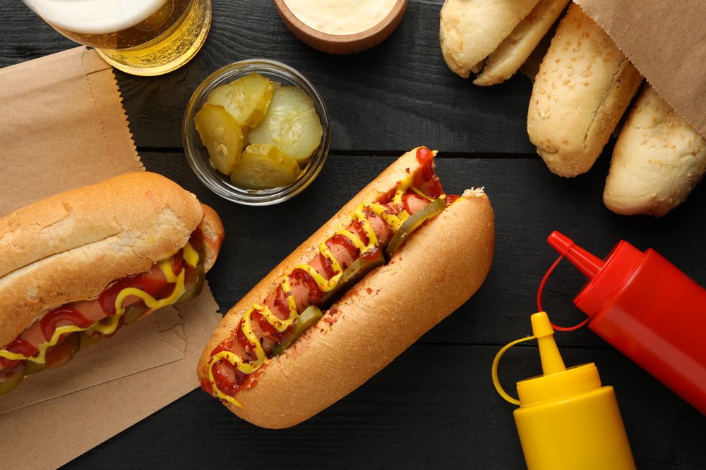 Composition with tasty hot dogs on wooden background