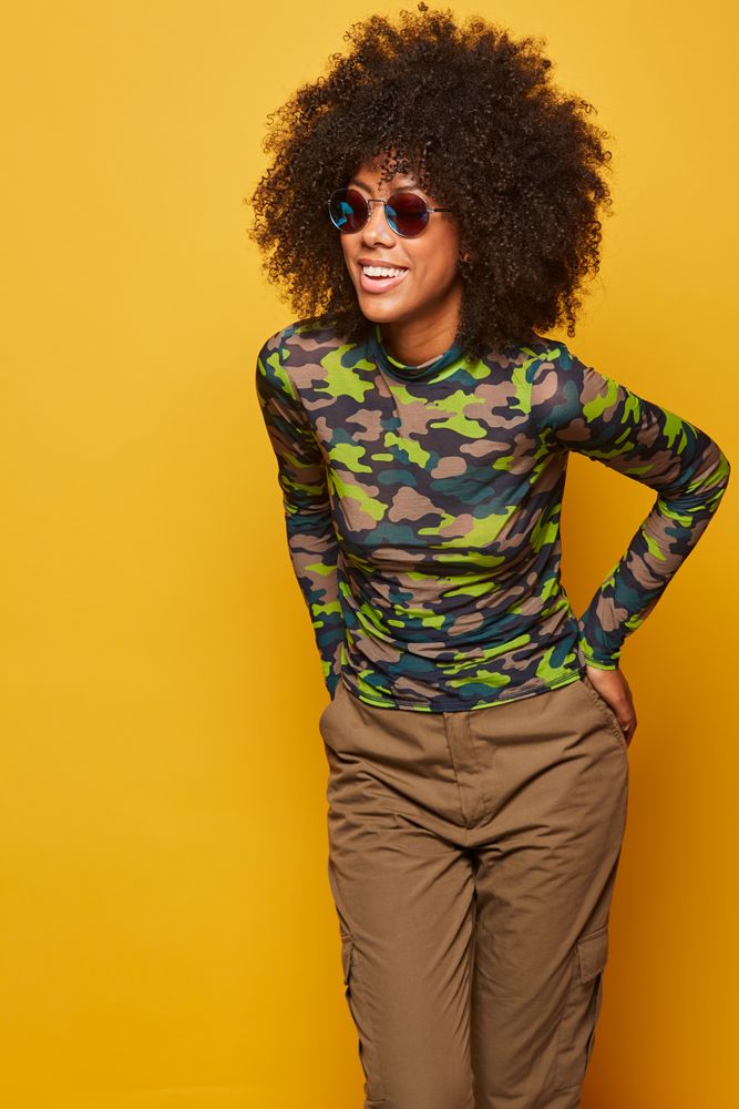 Woman in sunglasses on bright backdrop