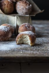 Baked cakes in craft paper on table