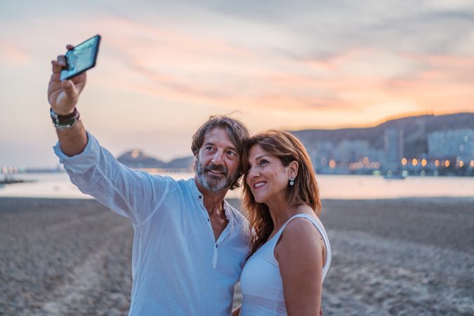 Adult couple taking selfie on beach