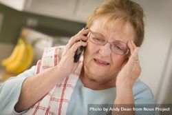 Shocked Older Adult Woman on Cell Phone in Kitchen 49mqQm