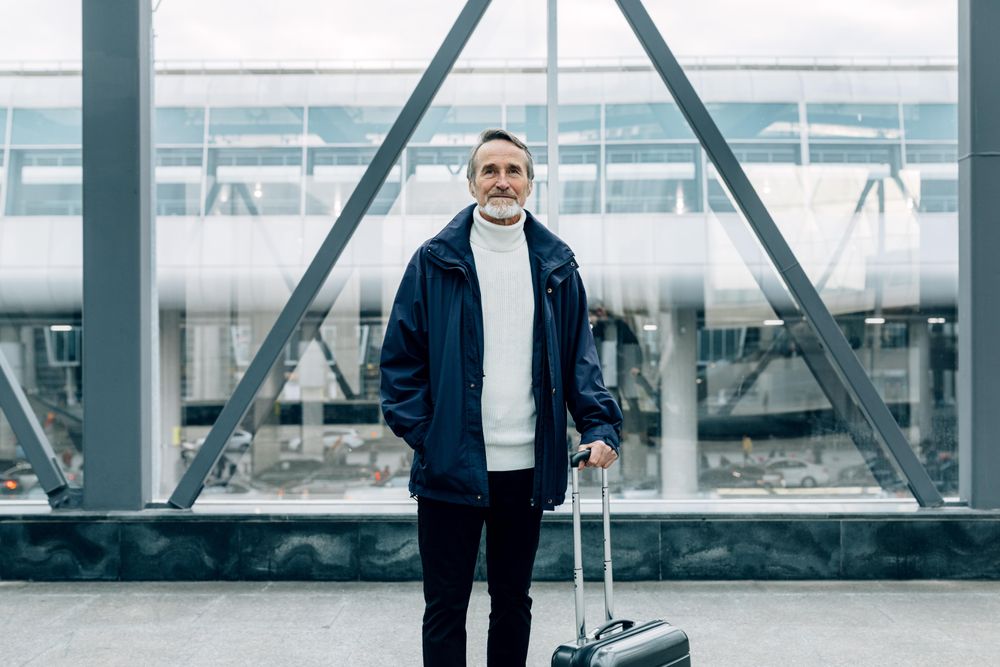 Stylish mature tourist standing outdoors