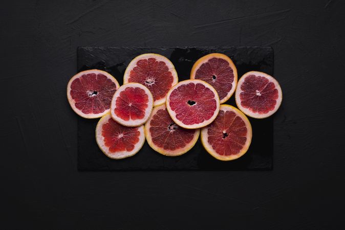 Blood orange slices on a dark table
