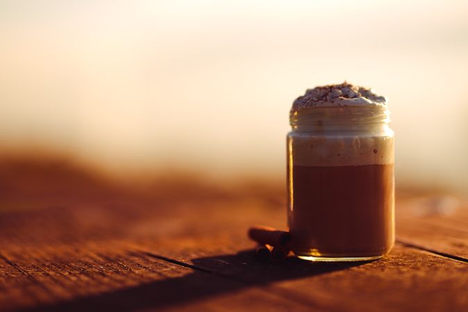 Cinnamon near coffee on table