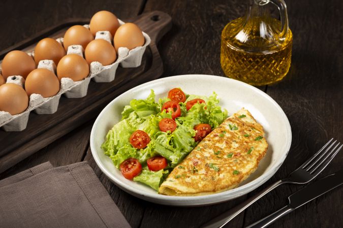 Omelet with cheese and lettuce and tomato salad.