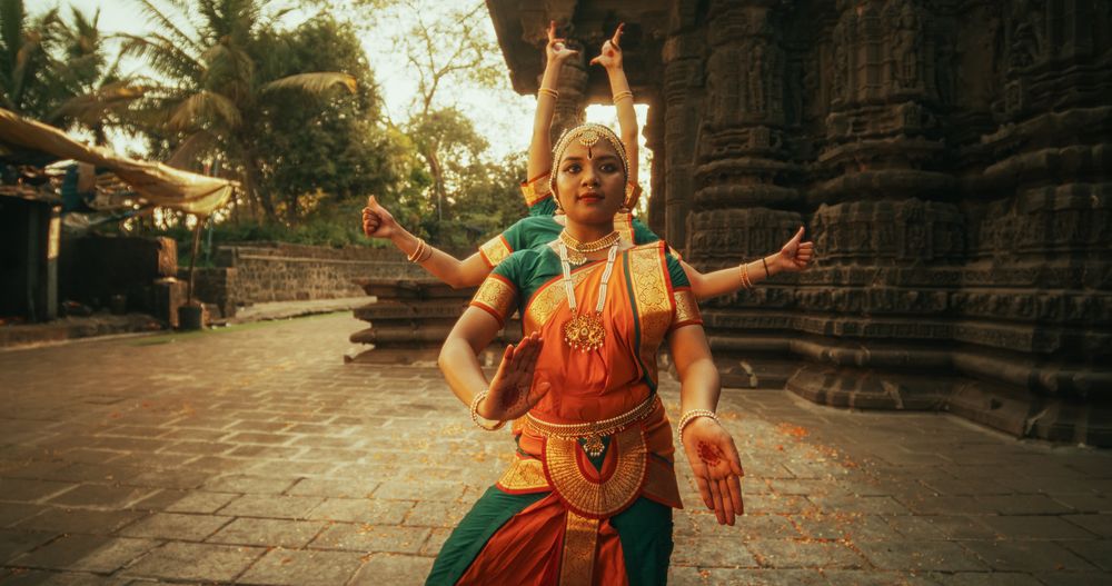 Portrait of Three Expressive Young Indian Dancers Performing Folk Dance Choreography in an Ancient Temple.