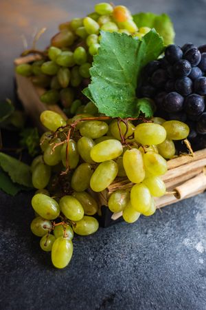 Box of fresh green & red grapes in kitchen