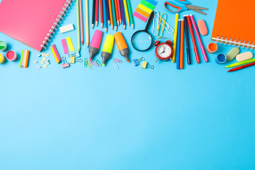 Flat lay composition with school supplies on color background, space for text