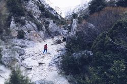 Woman walking between stone hills