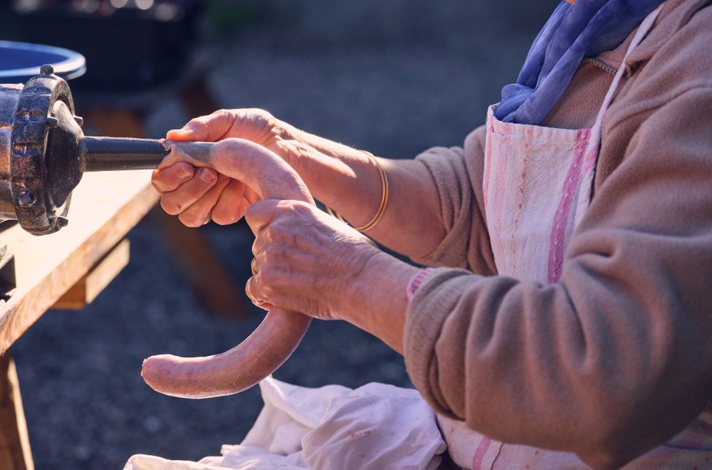 Anonymous elderly woman making sausage