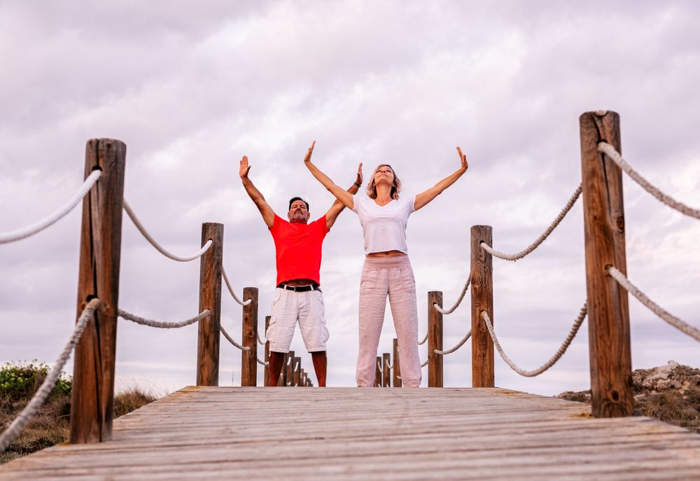 Couple practicing martial arts on lumber path