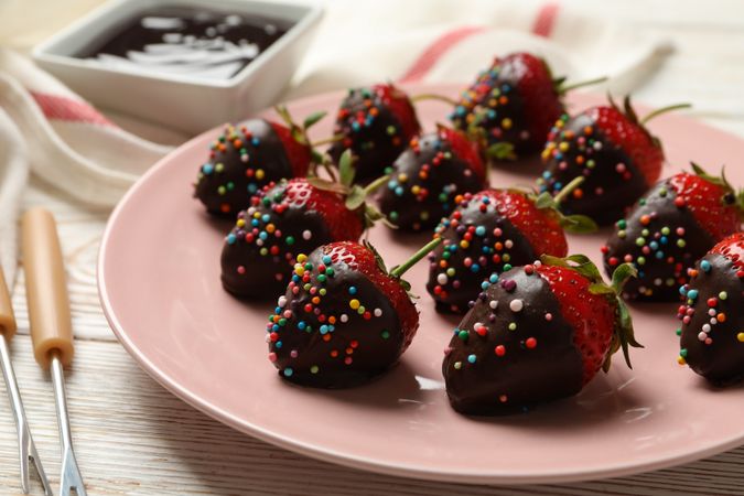 Chocolate fondue. Strawberry in chocolate on wooden background