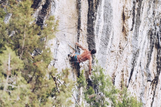 Anonymous man climbing rock