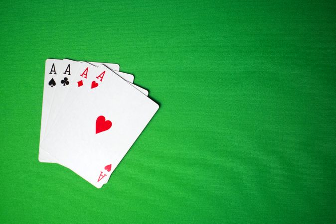 four aces card on green table