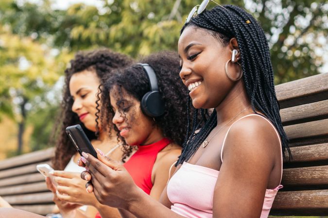 Black Female Friends Enjoying Summer Together and listening to music
