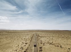 Car driving on road in picturesque desert