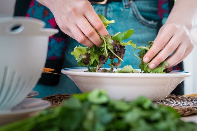 Woman preparing vegetable salad
