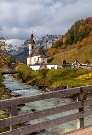 Church surrounded by mountains and autumn nature in the Bavarian Alps