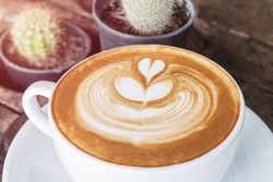 Cup of coffee latte on desk wooden, time already been enjoy coffee