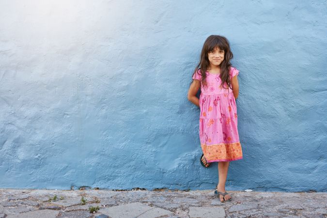 Full length portrait of pretty little girl looking at camera