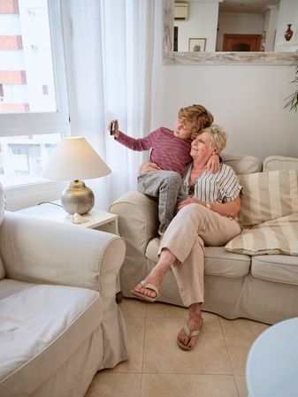 Grandma and grandchild having fun at home
